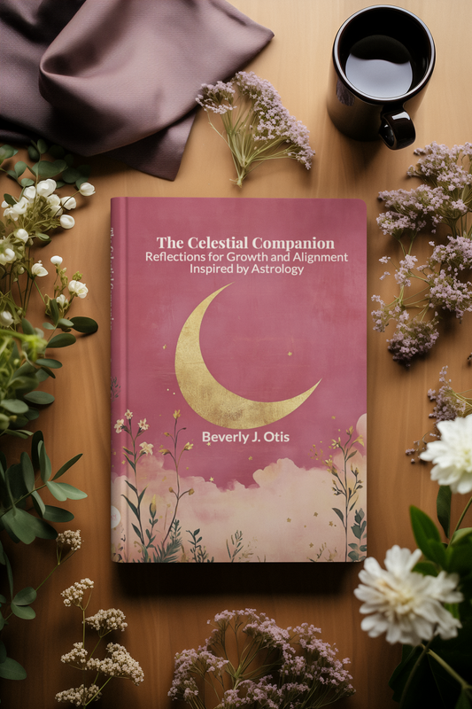 The Celestial Companion astrology journal by Beverly J. Otis on a wooden table surrounded by dried flowers, a satin cloth, and a cup of tea.